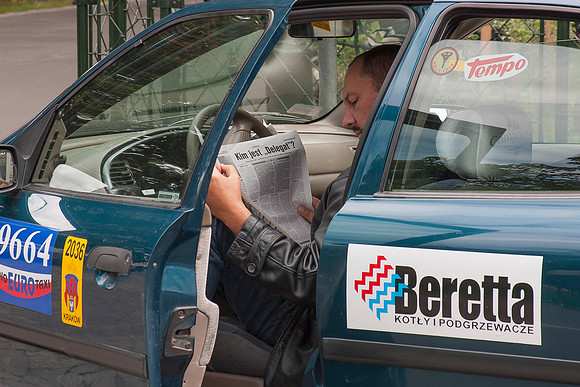 Taxi Driver Catching Up On News